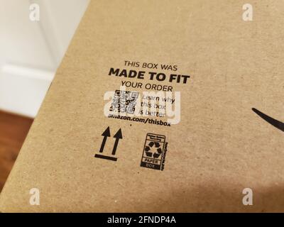 Primo piano delle informazioni sulla sostenibilità stampate su una scatola di cartone Amazon, tra cui un'etichetta "Made to Fit", un codice QR e il simbolo internazionale del riciclaggio, fotografato a Lafayette, California, il 12 febbraio 2021. () Foto Stock