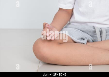 I bambini asiatici si siedono per la meditazione, la calma e il relax Foto Stock