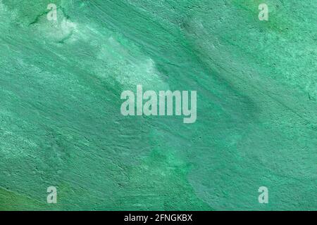 Splendido sfondo smeraldo ricco e luminoso di superficie in pietra di malachite. Consistenza irregolare e ruvida di vernice turchese verde, materiale di finitura o tessuto. Foto Stock