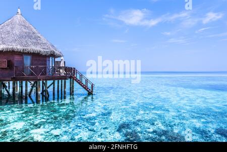 Parte del bungalow sull'acqua. Scale fino all'oceano. Riposa sul mare. L'uscita del rilassamento assoluto. Maldive. Resort su isola tropicale. Foto Stock