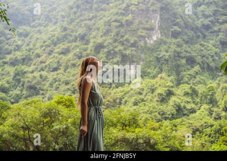 Donna turistica in Trang un complesso paesaggistico paesaggistico paesaggistico nella provincia di Ninh Binh, Vietnam UN sito patrimonio dell'umanità dell'UNESCO. Ripresa del turismo in Vietnam dopo Foto Stock