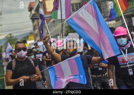 San Salvador, El Salvador. 17 maggio 2021. I manifestanti hanno le bandiere mentre cantavano slogan durante la dimostrazione.i membri della comunità LGTB sono scesi in piazza nella giornata internazionale contro omofobia, transfobia e bifobia, i dimostranti hanno protestato contro l'archiviazione di una legge che consentirebbe ai membri transgender di identificarsi come tali sulle loro carte di identificazione. (Foto di Camilo Freedman/SOPA Images/Sipa USA) Credit: Sipa USA/Alamy Live News Foto Stock