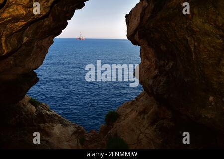 BIRZEBBUGA, MALTA - 10 giu 2015: La vista dalla grotta marina, formata da agenti atmosferici / erosione del calcare maltese. L'uscita della grotta si affaccia sul mare Foto Stock