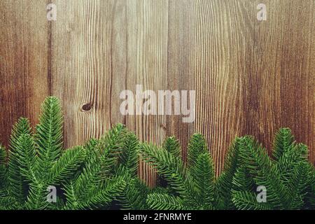 Sfondo natalizio con rami di abete cornice di bordo su sfondo di legno Foto Stock