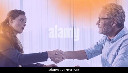 Composizione di uomo d'affari e donna d'affari che scuotono le mani in ufficio Foto Stock