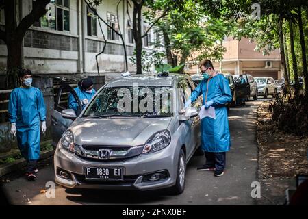 Bogor, Indonesia. 17 Marzo 2021. I medici assistono alle persone in un'auto presso un sito di vaccinazione drive-thru COVID-19. Il governo indonesiano ha aperto un drive attraverso COVID-19 Servizio di vaccinazione per le persone anziane a Bogor Credit: SOPA Images Limited/Alamy Live News Foto Stock