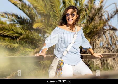 Una donna felice che ride in un parco Foto Stock