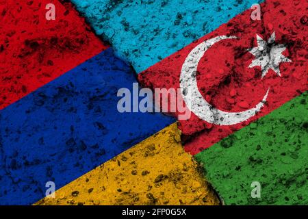 Concetto del conflitto tra Armenia e Azerbaigian con dipinto Bandiere su un muro e una rastrelliera tra loro Foto Stock