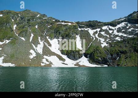 Atmosfera tranquilla sul lago del ghiacciaio Balea, conosciuto localmente come Balea lac, situato a un'altitudine di 2034 m, nei monti Fagaras in Romania Foto Stock