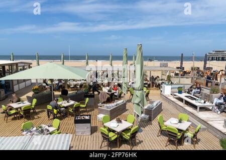 Scheveningen, Paesi Bassi - 16 maggio 2021: Si può gustare un pasto e un drink in uno dei ristoranti sulla spiaggia della località balneare di Schevenin Foto Stock