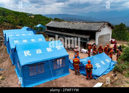 (210522) -- YANGBI, 22 maggio 2021 (Xinhua) -- i soccorritori costruiscono rifugi nel villaggio di Xiuling della Contea Autonoma di Yangbi Yi, provincia di Yunnan, 22 maggio 2021. Quattro terremoti di oltre 5.0 magnitudo hanno colpito la Contea Autonoma di Yangbi Yi nella Prefettura Autonoma di Dali Bai di Yunnan dalle 11 alle 22.00 venerdì ora di Pechino. I tremori sono stati avvertiti in tutte e 12 le contee e le città della prefettura, con Yangbi che è la più colpita. Finora, oltre 16,200 soccorritori e materiali di soccorso, comprese tende e beni di consumo quotidiano, sono stati spediti nell'area del terremoto. Oltre 22 milioni di yuan (circa 3.4 milioni Foto Stock