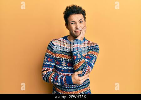 Giovane bell'uomo che indossa casual maglione invernale pensando stanco e annoiato con problemi di depressione con le braccia incrociate. Foto Stock