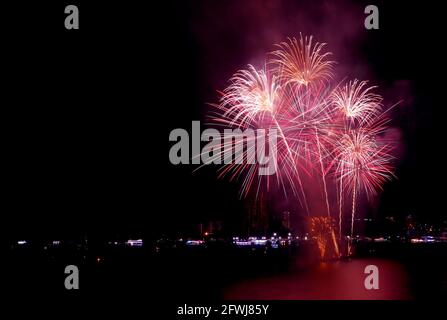 Splendidi fuochi d'artificio che spruzzi nel cielo notturno sulla città porto Foto Stock