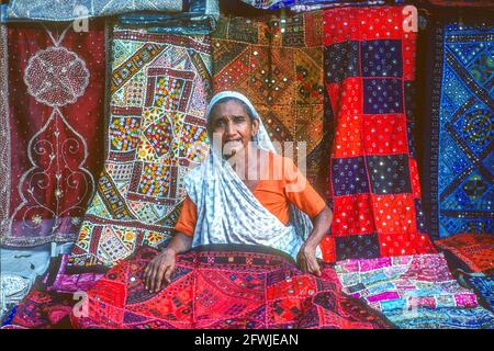 Donna venditore tessile Delhi India Foto Stock