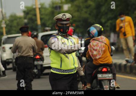 Madiun, Indonesia. 23 maggio 2021. Personale della polizia di Madiun durante il controllo di veicoli con targhe all'esterno e all'interno dell'area della reggenza di Madiun. Questa attività è nel contesto di una campagna per prevenire il virus corona o covid-19 socializzando il protocollo sanitario 5M, vale a dire lavarsi le mani con sapone con acqua corrente, indossare maschere, mantenere la distanza, limitare la mobilità e stare lontano dalla folla. (Foto di Ajun Ally/Pacific Press) Credit: Pacific Press Media Production Corp./Alamy Live News Foto Stock