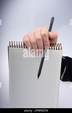 Mano umana che usa la penna per scrivere una breve nota notebook Foto Stock