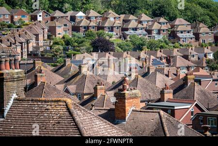 Tetti suburbani. Una vista elevata su una tenuta suburbana del dopoguerra degli anni '50 ai margini del centro storico di Eastbourne, sostenuta da antichi boschi. Foto Stock