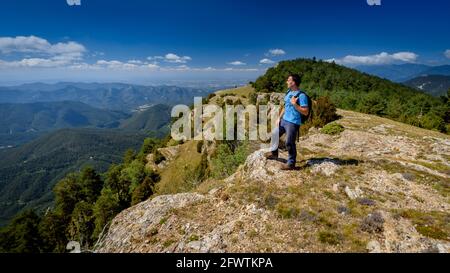 Escursionista che guarda i Pirenei orientali dalla Serra del Catllaràs in estate (Berguedà, Barcellona, Catalogna, Spagna, Pirenei) Foto Stock