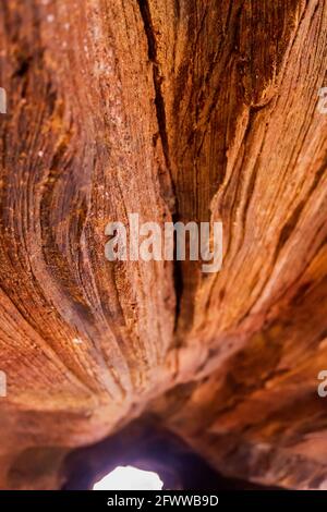 interno di una grotta attraverso la quale un raggio di luce filtra, erose rocce di arenaria Foto Stock