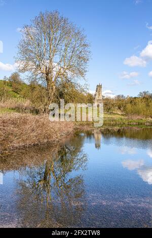 Le rovine della chiesa di St Martins si sono riflesse in un laghetto di mulino abbandonato a Wharram Percy deserted Medieval Village sul Yorkshire Wolds, North Yorkshire, Foto Stock