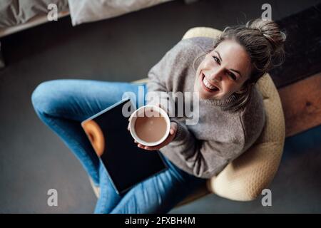 La proprietaria era felice di tenere la ciotola del cappuccino mentre era seduto al bar Foto Stock