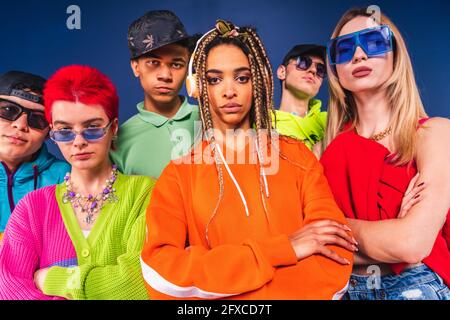 I giovani amici con le braccia incrociarono in piedi insieme Foto Stock