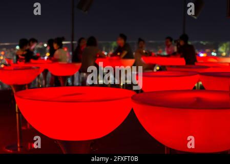 Tavoli rossi presso un bar sul tetto, Saigon Foto Stock