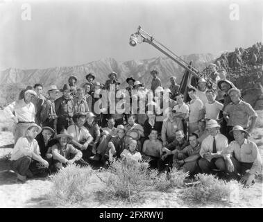 Cast e Crew del 1 ° film Hopalong Cassidy HOP-A-LONG CASSIDY 1935 sulla posizione impostata foto di gruppo candid tra cui JAMES ELLISON di fronte al regista HOWARD BRETHHERTON (sotto la fotocamera) WILLIAM BOYD e cinematografo ARCHIE STOUT (casco pith) GEORGE ''GABBY'' HAYES (3 ° a sinistra in prima fila) e FRANK McGLYNJr (A sinistra di cavallo) romanzo Clarence E. Mulford Harry Sherman Productions / Paramount Pictures Foto Stock