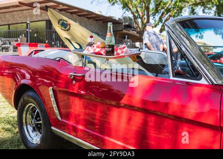 Marble Falls, Texas, Stati Uniti. 10 aprile 2021. Vintage Ford Mustang con un vassoio di cibo drive-in Foto Stock