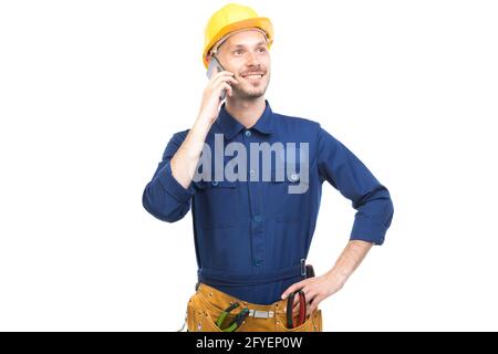 Orizzontale medio ritratto di successo bel giovane adulto caucasico costruzione ingegnere indossando uniforme parlando al telefono, sfondo bianco Foto Stock