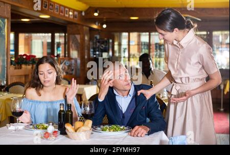 Triangolo d'amore - moglie ha preso il marito con la padrona in un ristorante Foto Stock