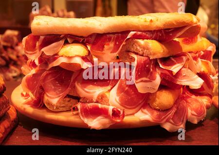 Una pila di panini al prosciutto di serrano iberico in esposizione presso un paninoteca locale a Bilbao, Biscay, Paesi Baschi, Spagna Foto Stock