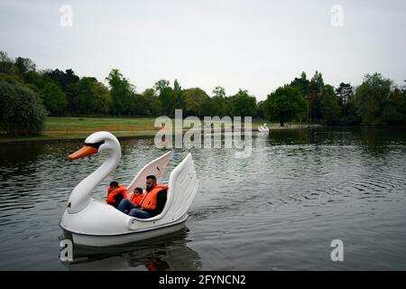 Una famiglia usa un pedalo al Cannon Hill Park a Birmingham, con il fine settimana delle vacanze bancarie previsto per portare i cieli azzurri e sole diffuso. Data immagine: Sabato 29 maggio 2021. Foto Stock