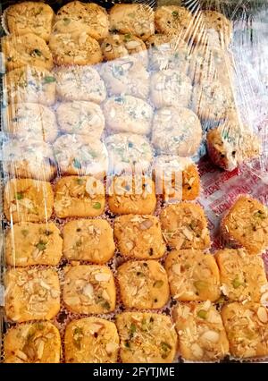 Closup di dolci indiani allettanti in un negozio, New delhi, india - novembre 2020: Un primo piano di dolci colorati ben disposti in un negozio commerciale della città. Foto Stock