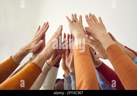 Le persone che tengono le mani unite insieme mostrano il closeup della forza di lavoro di squadra scatto Foto Stock