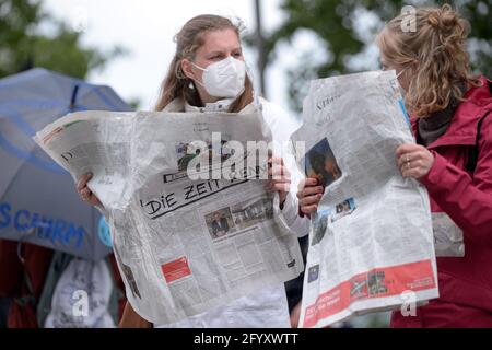 Amburgo, Germania. 27 maggio 2021. Gli attivisti della ribellione dell'estinzione stanno tenendo giornali che dicono che 'il tempo sta esaurendo'. Diversi gruppi locali di ribellione per l'estinzione hanno chiesto di riferire meglio sulla crisi climatica in caso di azioni decentrate di fronte alle case dei media sotto il motto "crisi climatica sulle prime pagine". Credit: Jonas Walzberg/dpa/Alamy Live News Foto Stock