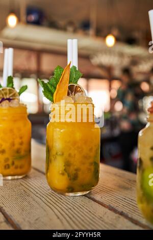 Set di rinfrescanti vari cocktail mojito tra cui pesca alla fragola e. sapori classici serviti al tavolo nel bar Foto Stock