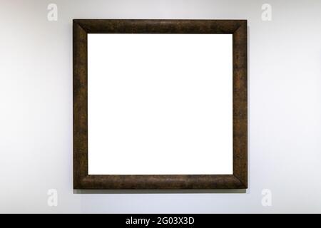 cornice quadrata marrone scuro con tela ritagliata su bianco parete Foto Stock