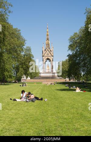 I giovani si rilassano il lunedì delle festività di fronte all'Albert Memorial, Kensington Gardens, Kensington, Londra, W8, Inghilterra, Regno Unito Foto Stock