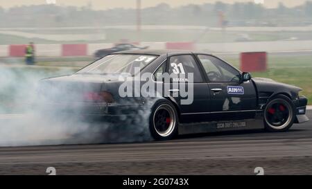 Mosca, Russia. 29 maggio 2021. Fumo visto da sotto le ruote di un'auto sportiva grigia durante l'evento.Festival Drift Expo Track Mode si svolge il 29-30 maggio presso ADM Raceway con la mostra di progetti modificati per il drifting come; ''˜Drift Taxi' - un'opportunità per viaggiare come passeggero con un autista professionista in una macchina sportiva appositamente preparata sulla pista da corsa, ''˜Drift Trike Area' - una piattaforma dove si può provare a guidare un vero e proprio trike di deriva e ''˜RC Drift' - deriva su auto radiocomandate. Credit: Mihail Siergiejevicz/SOPA Images/ZUMA Wire/Alamy Live News Foto Stock