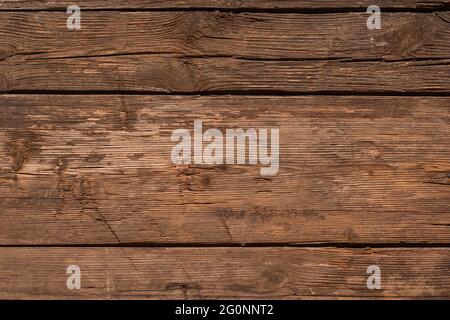 Sfondo in legno d'epoca. Vecchia struttura in legno con crepe, graffi, ammaccature. Foto Stock