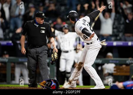 L'infedelder di Colorado Rockies Ryan McMahon (24) segna il gioco che ha vinto un campo selvaggio durante una partita di stagione regolare di MLB contro i Texas Rangers, Foto Stock