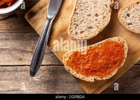 Pane tostato affettato con sobrasada su tavola rustica di legno Foto Stock