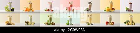 Set di frullati di latte con panna in vetro alto decorato con frutti di vario gusto su tavolo bianco e sfondo colorato isolato. Vista frontale. Foto Stock