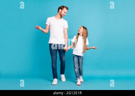 Foto di dimensioni complete di bel ragazzo cute pupilla tenere le braccia guardare l'un l'altro parlare chiacchierando isolato su sfondo di colore blu Foto Stock