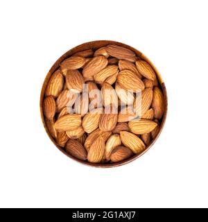 Noci di mandorle grezze nella ciotola rotonda di legno isolata su sfondo bianco. Foto Stock