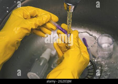 Esperimenti e esperimenti in laboratorio. Uno scienziato in guanti gialli conduce analisi chimiche e test. Il lavoro di un medico, estetista e. Foto Stock