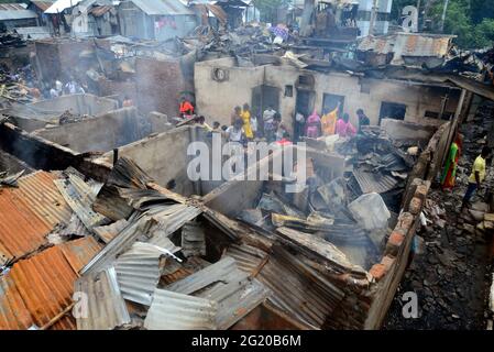 Gli abitanti delle Slum del Bangladesh hanno visto la ricerca dei loro beni domestici dopo un devastante incendio scoppiato nello slum di Mohakhali a Dhaka, Bangladesh, il 7 giugno 2021. Almeno 300 shanties sono stati eviscerati come il devastante fuoco che è scoppiato a Mohakhali slum a Dhaka. Foto Stock