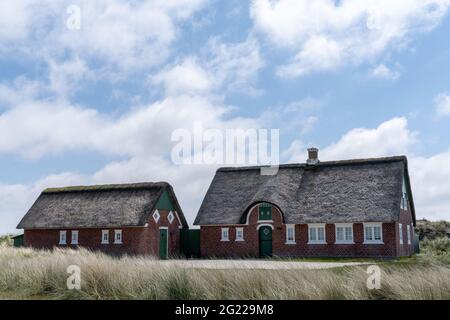 Sonderho, Danimarca - 29 maggio 2021: Tradizionale casa danese con tetto di paglia canna in un paesaggio di dune di sabbia costiera Foto Stock