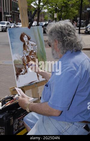 ST. CHARLES, STATI UNITI - 26 aprile 2009: Un artista al lavoro su un dipinto a St. Charles, Missouri. Foto Stock